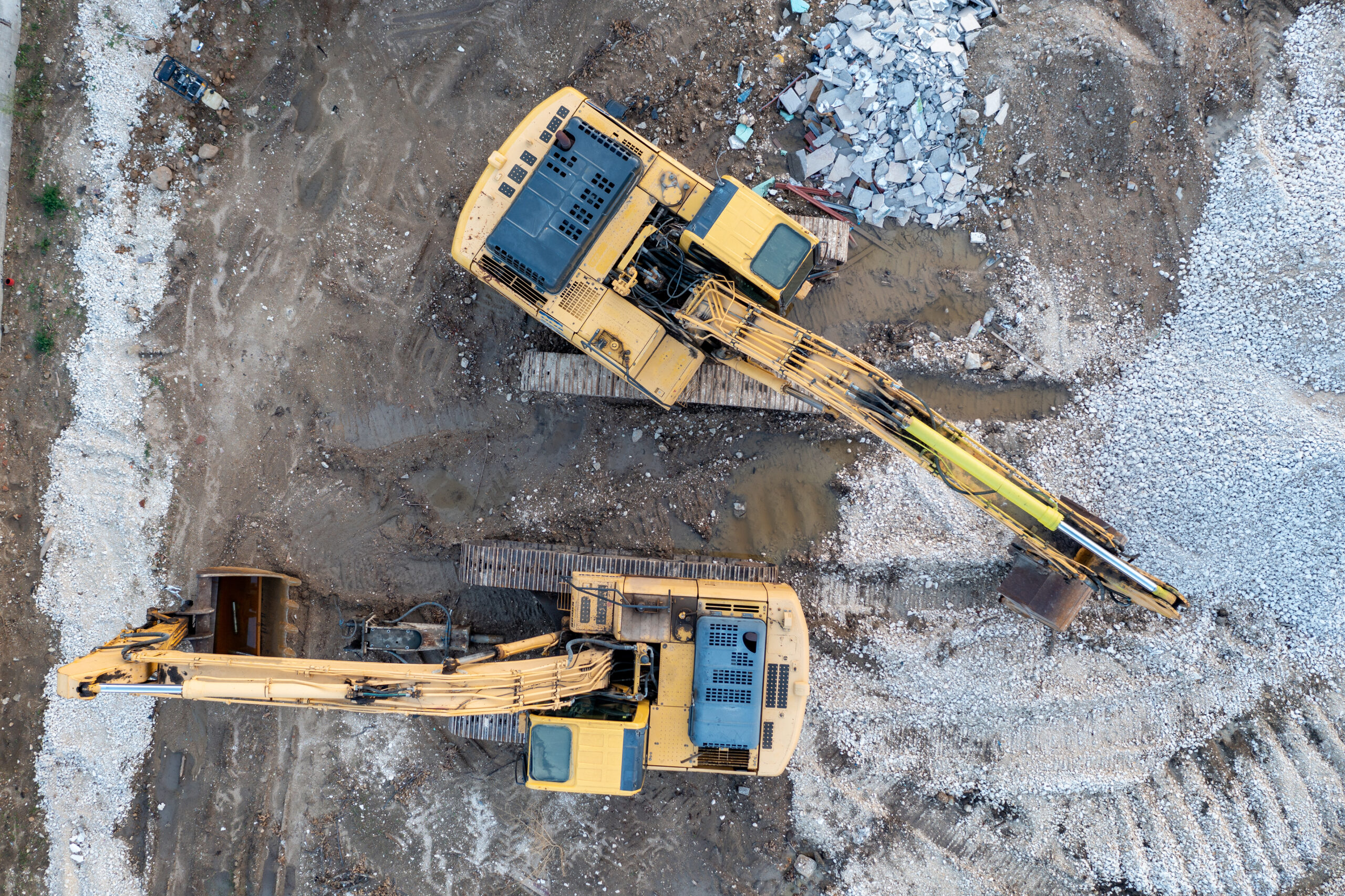 Stunning aerial view of the stopped yellow excavators at a construction site